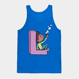 boy blows soap bubbles while sitting on the letter L Tank Top